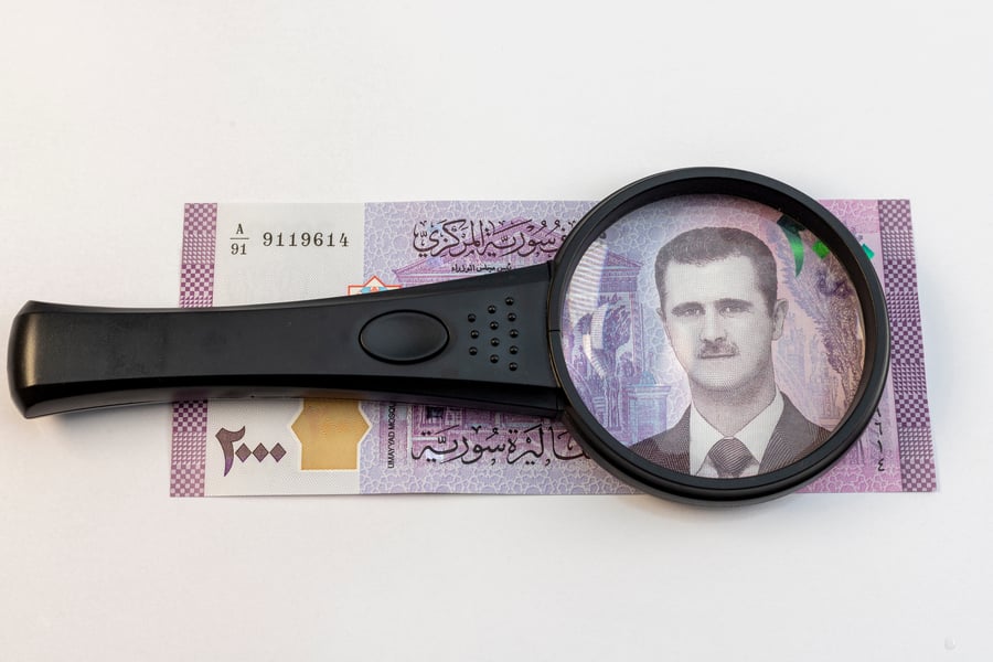 Magnifying glass focused on President Bashar Al Assad