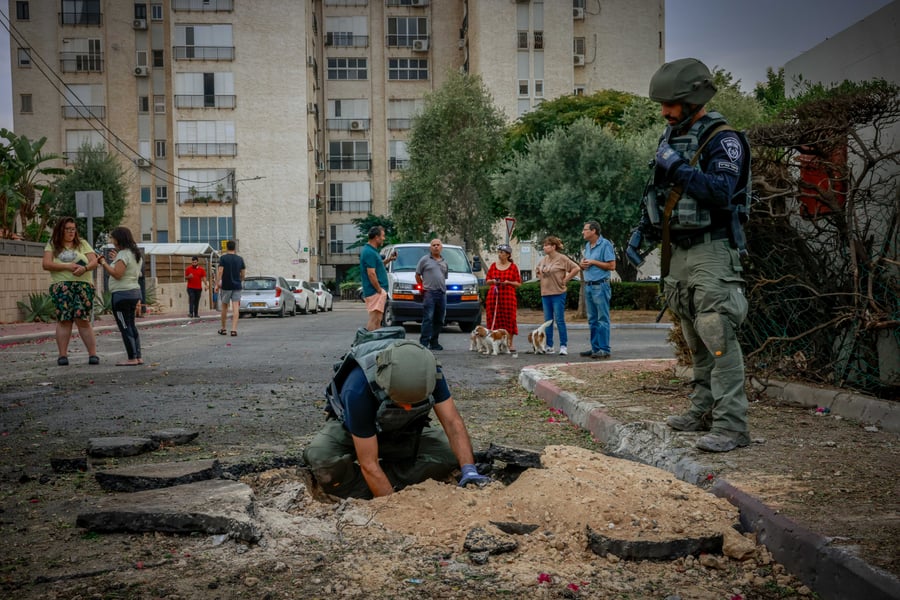 Police at the scene where a rocket fired from the Gaza Strip hit a road and cars in Ashkelon