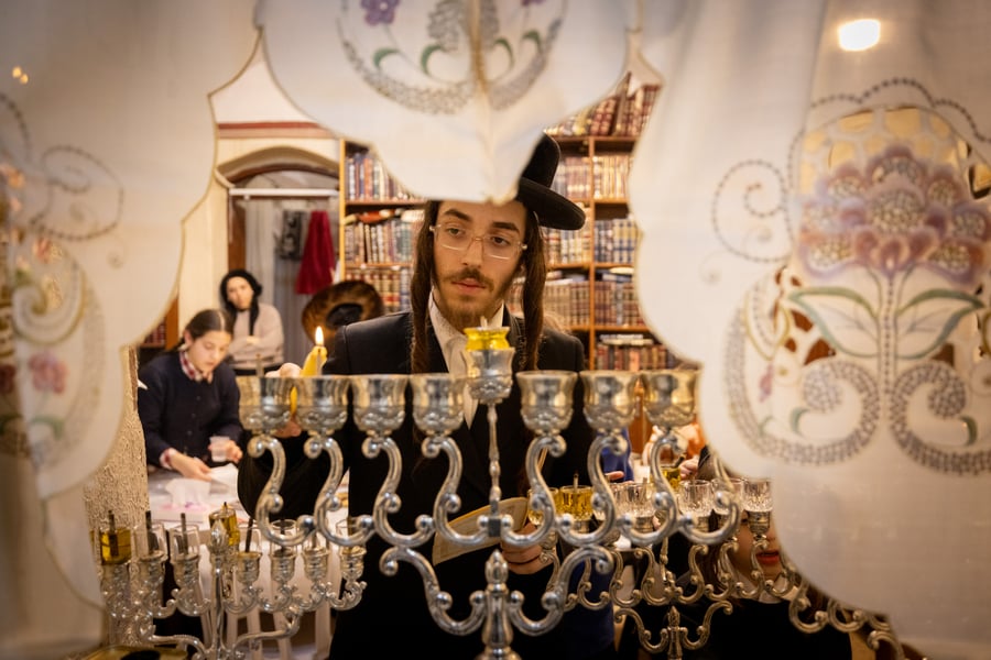 Ultra-Orthodox Jews light candles on the second night of the Jewish holiday of Hanukkah, in Jerusalem's Mea Shearim neighbourhood on December 26, 2024. 