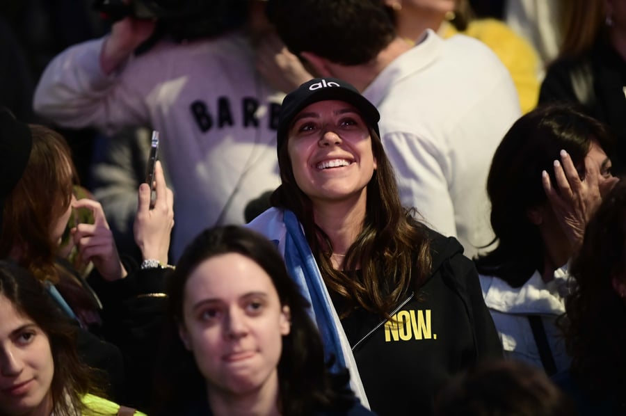 Israelis watch the release of three hostages from Hamas captivity as part of a deal between Israel and Hamas, at hostage square in Tel Aviv, January 19, 2025.