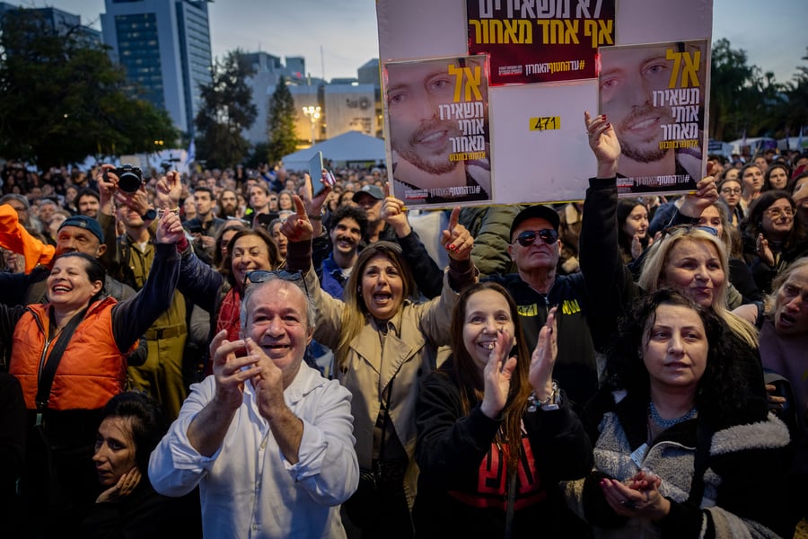 sraelis watch the release of three hostages from Hamas captivity as part of a deal between Israel and Hamas, at hostage square in Tel Aviv, January 19, 2025