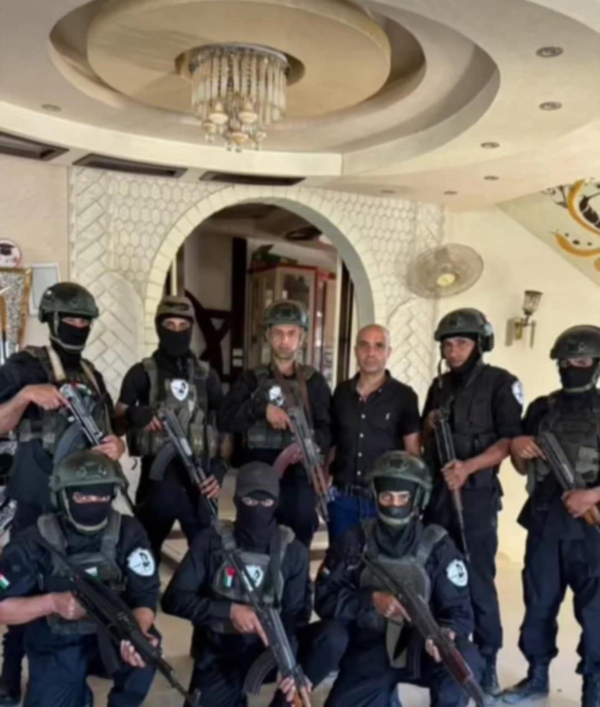 Abu Shabab’s militia members pose for a photo at the palace in Rafah that serves as their base.