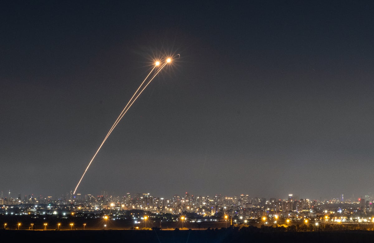 Anti-missile system fires interception missiles as missiles fired from Iran as it seen over central Israel, June 19, 2025.