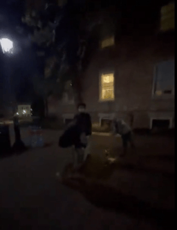 Students removing hostage names written on the ground.