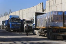 Trucks with aid arrive at the Palestinian side of the Kerem Shalom border crossing, in the southern Gaza Strip, on February 17, 2024. 