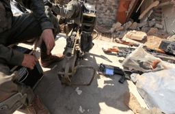 IDF soldiers near weapons found in southern Lebanon during raids.