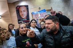 MK Almog Cohen reacts next to families of Israelis who were murdered by Hamas terrorists at the Nova festival at the Knesset, the Israeli parliament in Jerusalem on February 10, 2025. 
