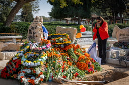 Mourners near the fresh grave of late Israeli hostages Shiri Bibas and her children Ariel and Kfir at the cemetery in Tzohar, southern Israel, February 26, 2025.