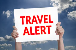 Travel Alert card with cloud background 