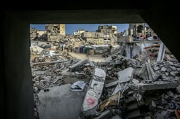 Palestinians inspect the rubble of the Ahmed family's home after it was bombed in an Israeli airstrike