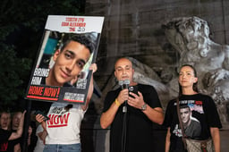 Adi Alexander speaks with Yael at his side, parents of Edan Alexander