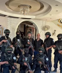 Abu Shabab’s militia members pose for a photo at the palace in Rafah that serves as their base.