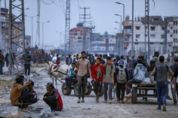Palestinians walking near aid distribution point in the Netzarim Corridor in the central Gaza Strip on June 9, 2025. 