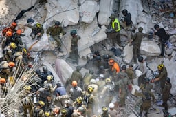 Home Front Command forces at the scene where a ballistic missile fired from Iran hit and caused damage in Bat Yam, central Israel. June 15, 2025. 