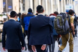 Ultra orthodox yeshiva student walk past a religious soldier on Jaffa road in Jerusalem