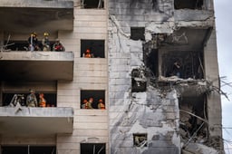 Israeli security and rescue forces at the scene where a ballistic missile fired from Iran hit and caused damage in Petah Tikva, June 16, 2025.