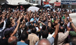 Palestinian supporters of the Hamas radical Islamist movement shout slogans during a demonstration in support of the Muslim Brotherhood in Egypt 