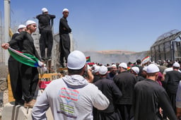 Druze residents protest near the Israeli-Syrian border fence in solidarity with their community in Syria, in Majdal Shams, July 16, 2025. 