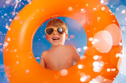 Happy child playing in waterpark