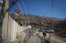 Israeli security forces stand guard at the Israeli border fence with Syria, near the Druze town of Majdal Shams in the Golan Heights, July 19, 2025. 