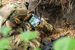 Soldier using satellite communication device