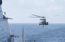An MH-60R Sea Hawk helicopter approaches USS Delbert D. Black (DDG 119) after patrolling the Arabian Sea in support of the U.S. blockade against Iran. 