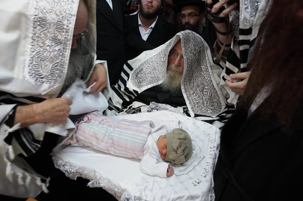 Illustration: The rebbe of Sadigora takes part at a circumcision ceremony in the city of Bnei Brak