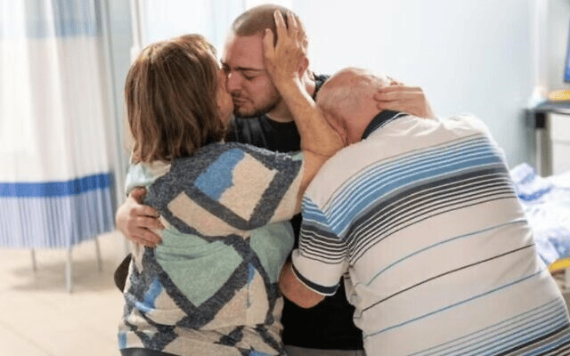 Rescued hostage Almog Meir Jan is reunited with his family