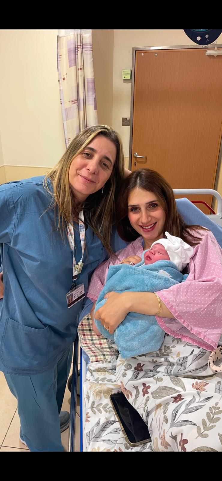 The happy mother and her nurse.