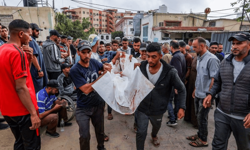 Gazans mourning outside of a hospital