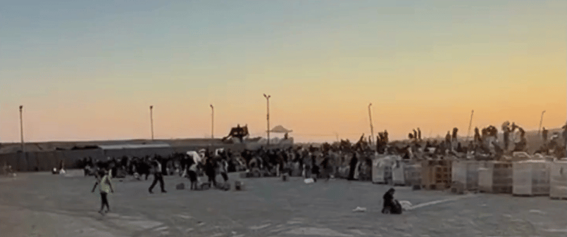 Gazans waiting for aid at a GHF station.