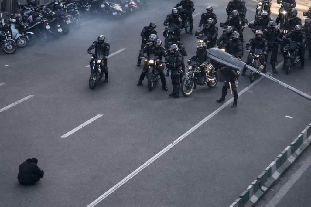 A lone protestor faces down Iranian regime forces.