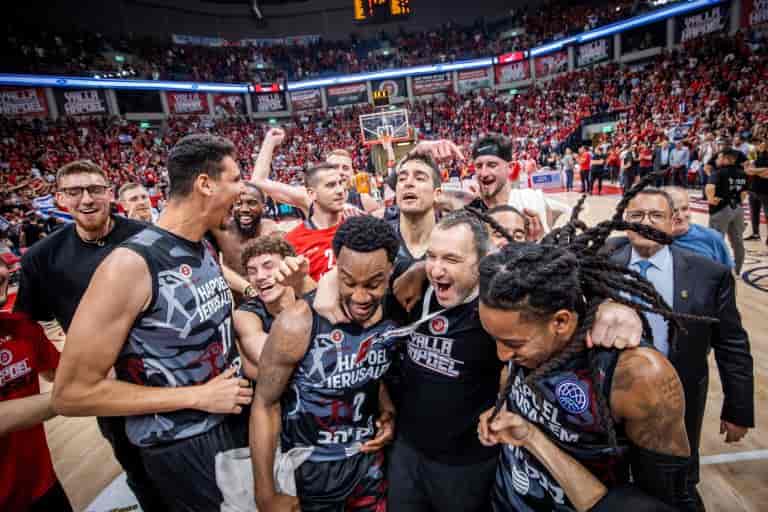 Hapoel Jerusalem players celebrate advancing to the Final Four of the Champions League last season background