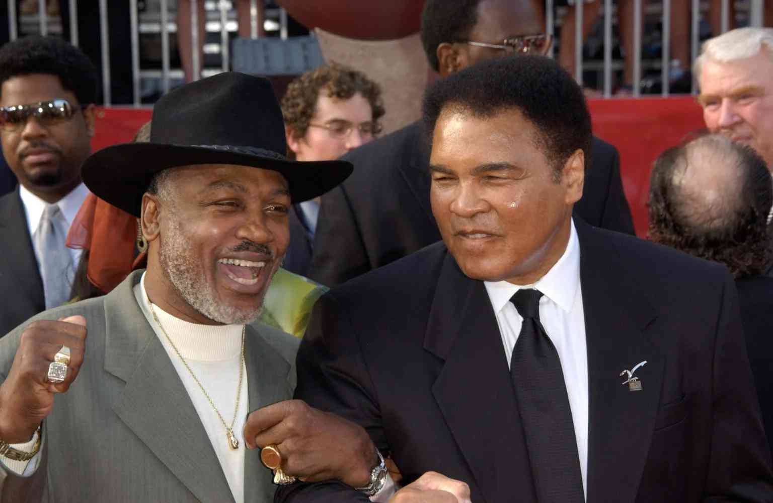 Joe Frazier and Muhammad Ali in 2002 background