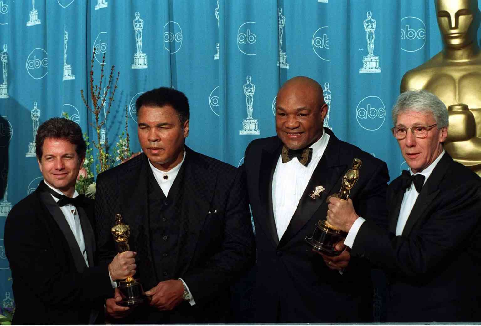 Muhammad Ali and George Foreman together with the creators of the movie "When We Were Kings" background
