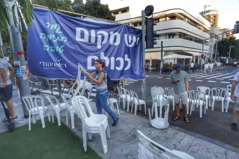 Protesters fold the chairs in the square background