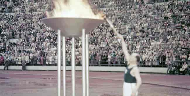 Paavo Nurmi lights the Olympic torch background