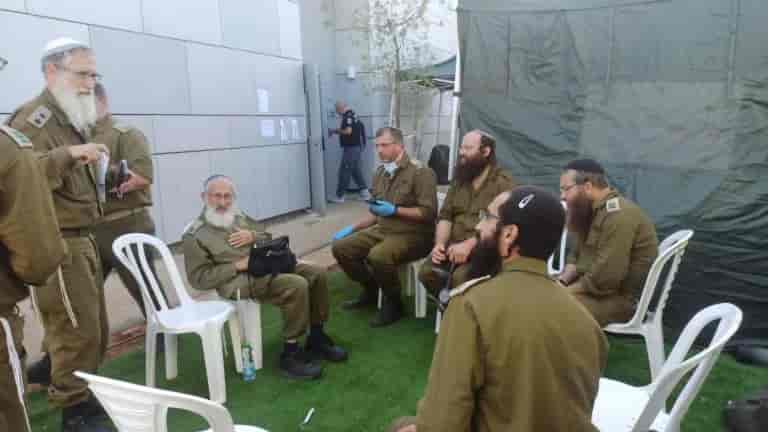 Rabbi Aviner being briefed. background