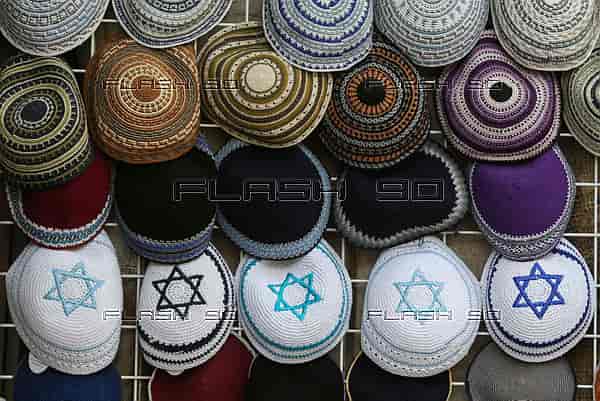 Almost 70% of British Jews less likely to wear things like kipahs due to antisemitism. Kipahs for sale in Jerusalem. background