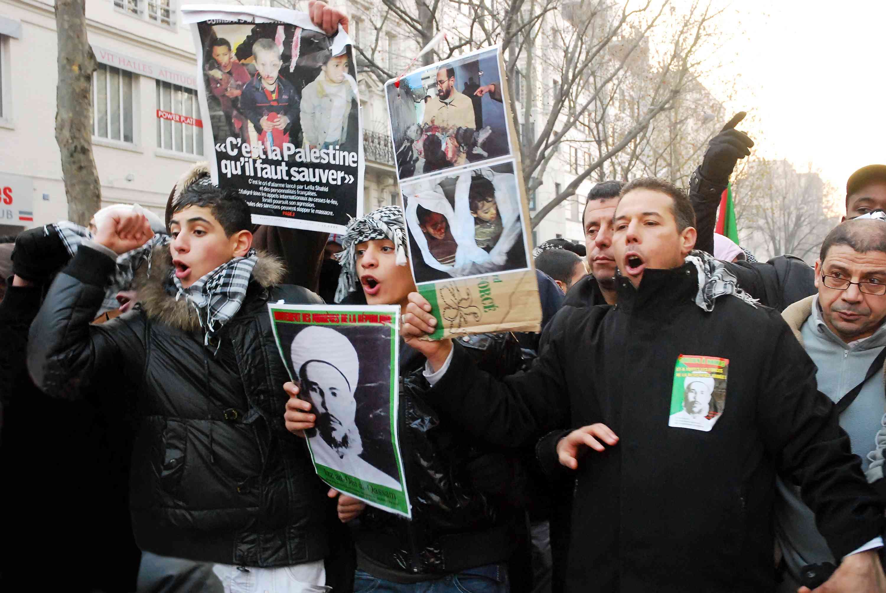 Opposed to Israel's war, divided on Hamas' actions. French Muslims protesting a previous round of conflict in Gaza. background