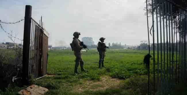 IDF soldiers in Gaza background