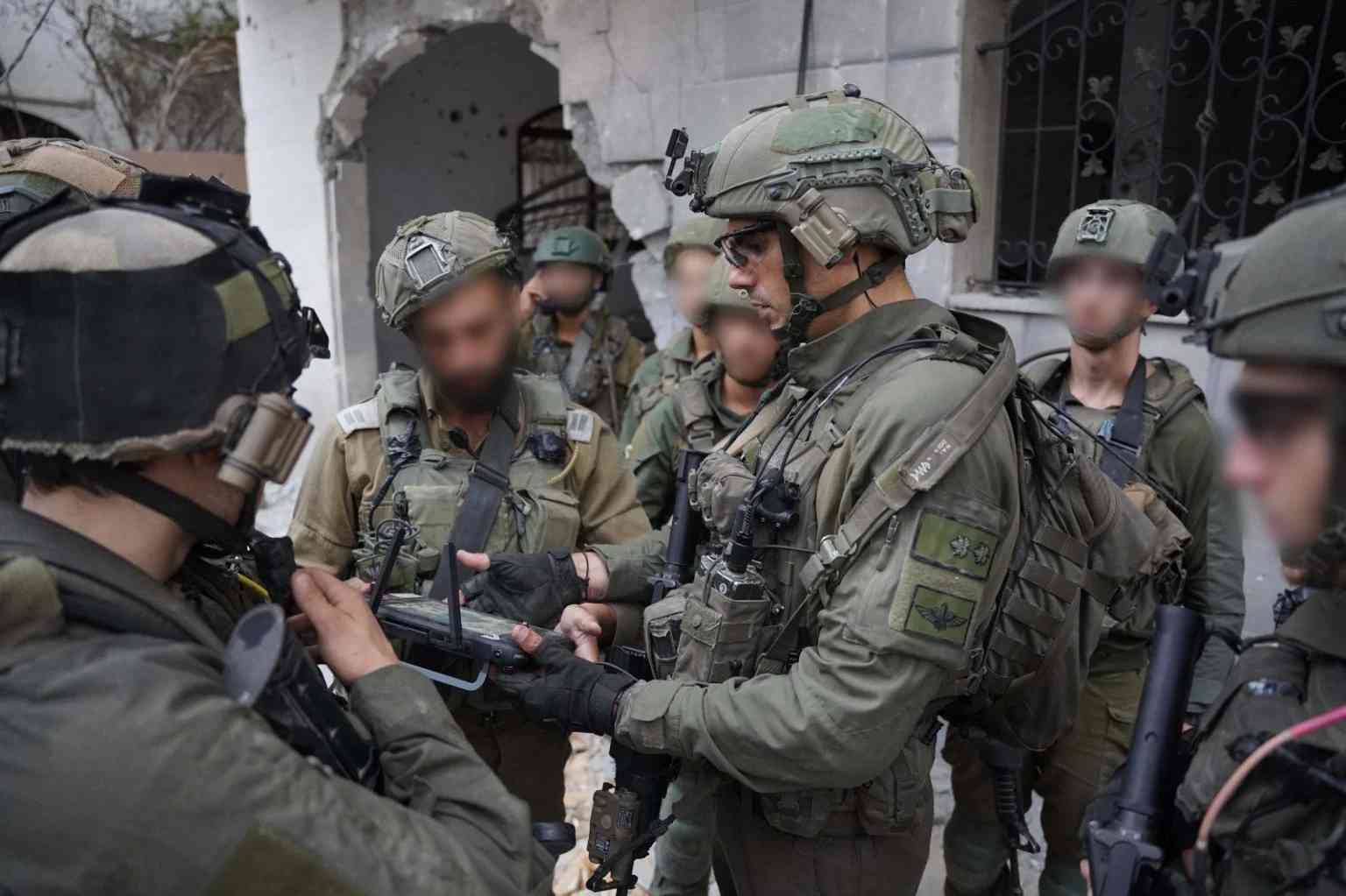 IDF soldiers in Gaza background