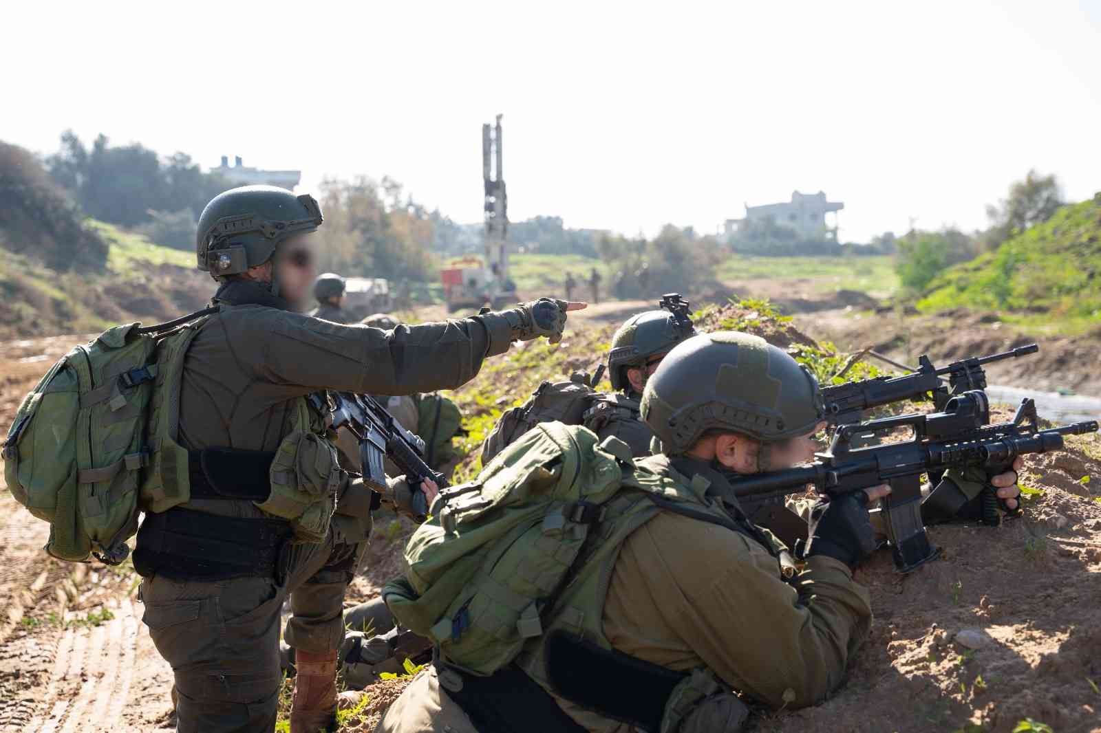 IDF soldiers in Gaza background