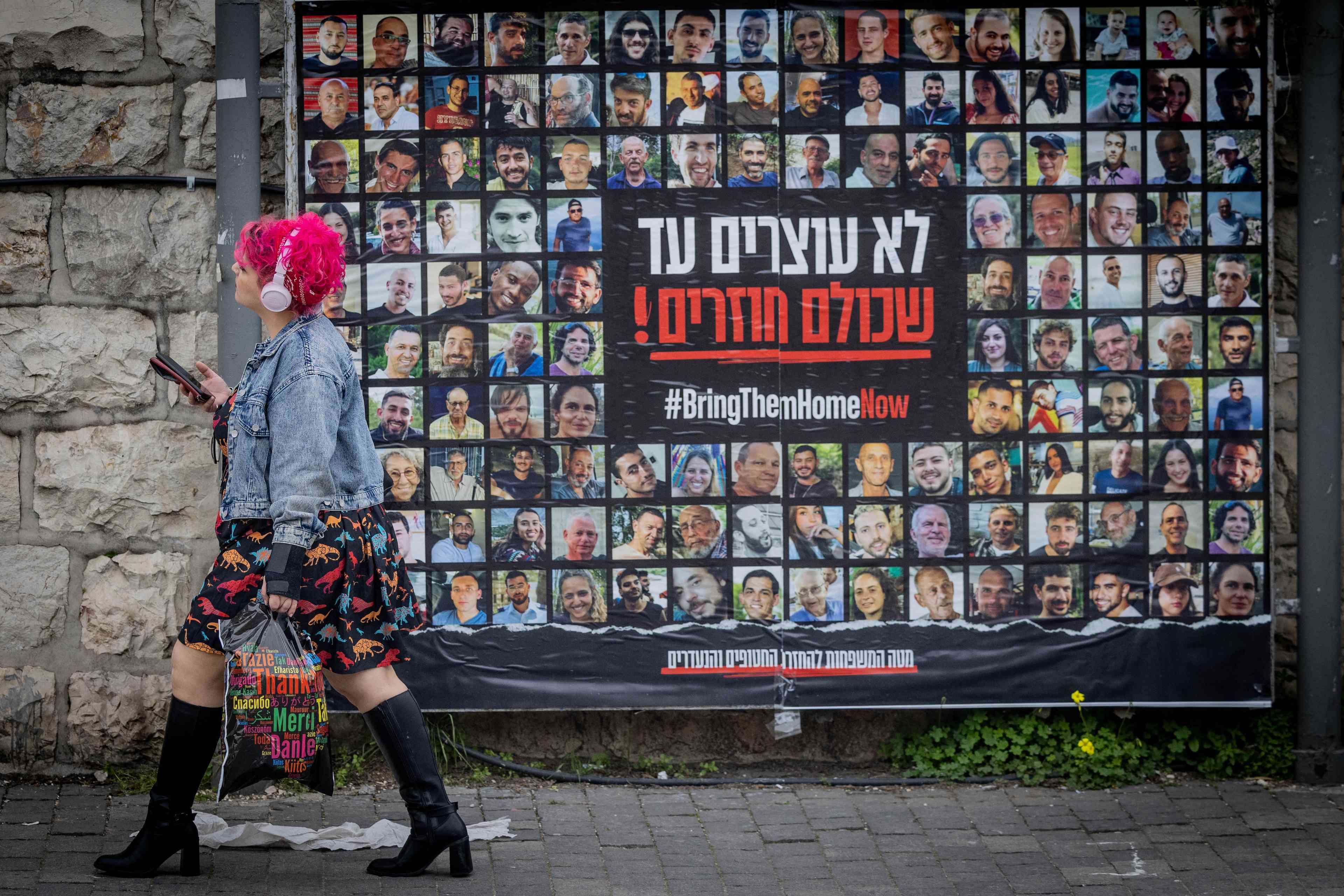 "We don't stop until they all come back!" Poster calling for the return of the hostages. background