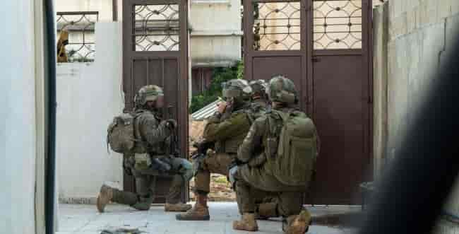 IDF soldiers in Rafah, Gaza background