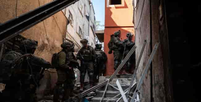 IDF soldiers in Gaza background