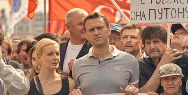 Alexei Navalny at a protest with his wife background