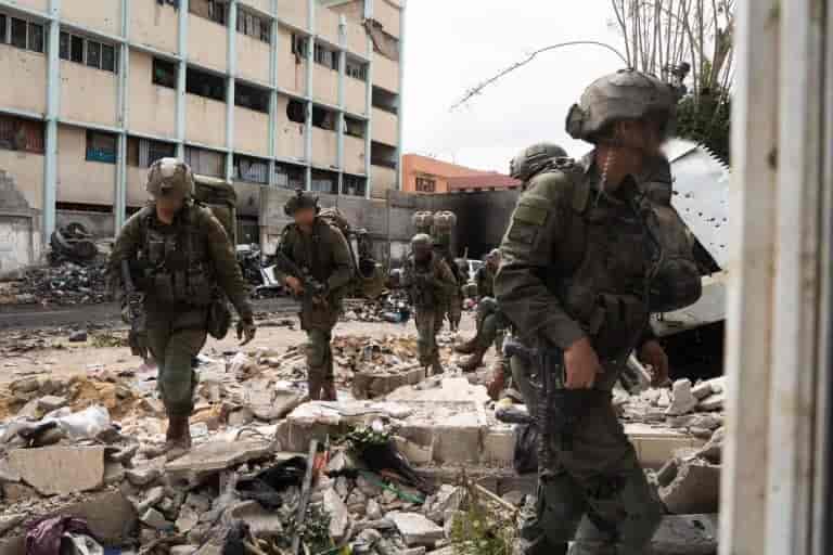 IDF soldiers at Shifa Hospital in Gaza background