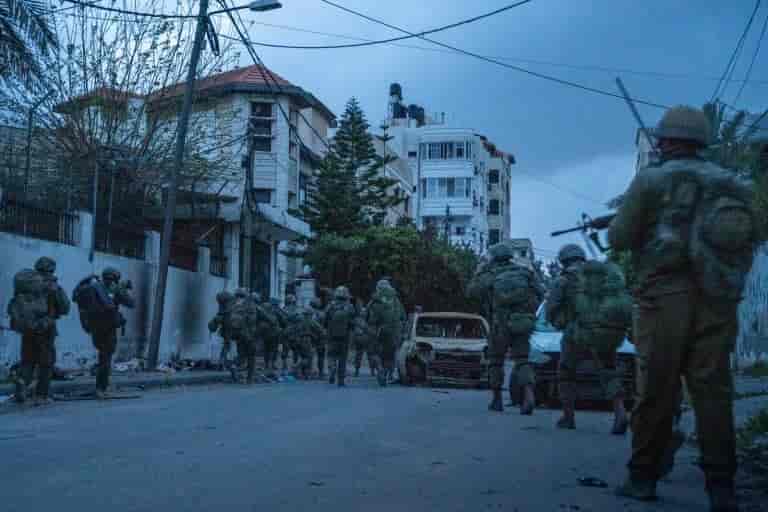 IDF soldiers at Shifa Hospital in Gaza background