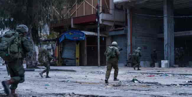 IDF soldiers in Gaza background